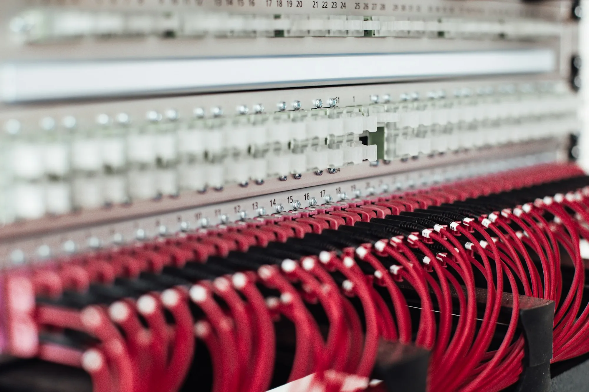 Network switches in a rack with rows of neatly run patch cables