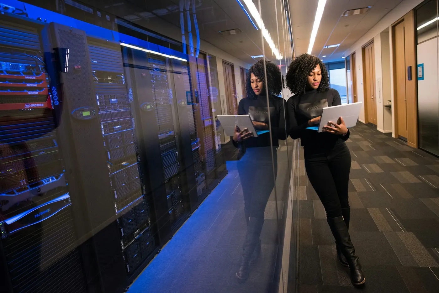 IT technician with a tablet in a server room